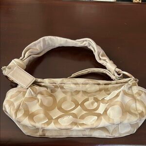 Coach Cream Signature Shoulder Bag with Rise Gild hardwear details.